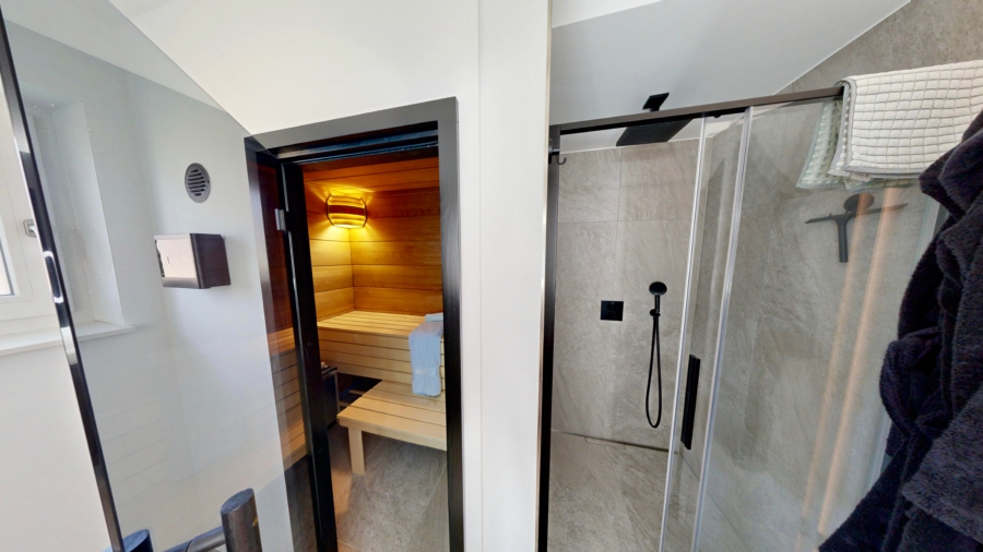 Wellnessbad mit hochwertigen Materialien und integrierter Sauna