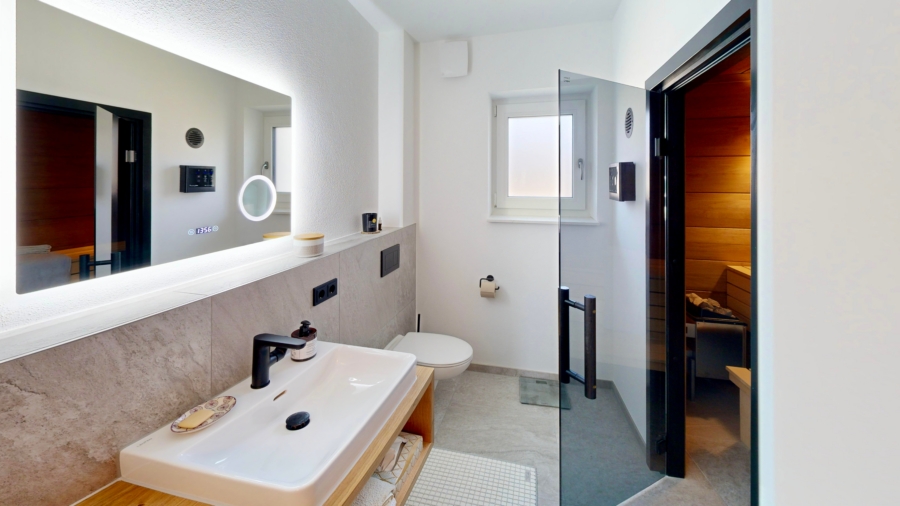 Wellnessbad mit hochwertigen Materialien und integrierter Sauna